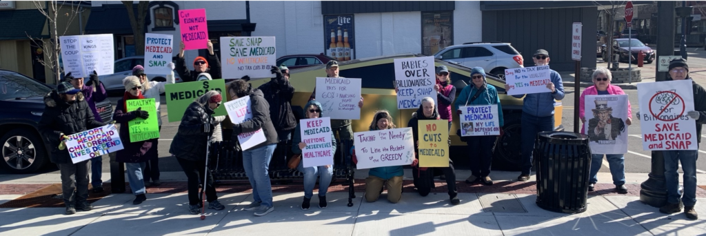 Indivisibles in front of a cybertruck downtown Mt. Pleasant.